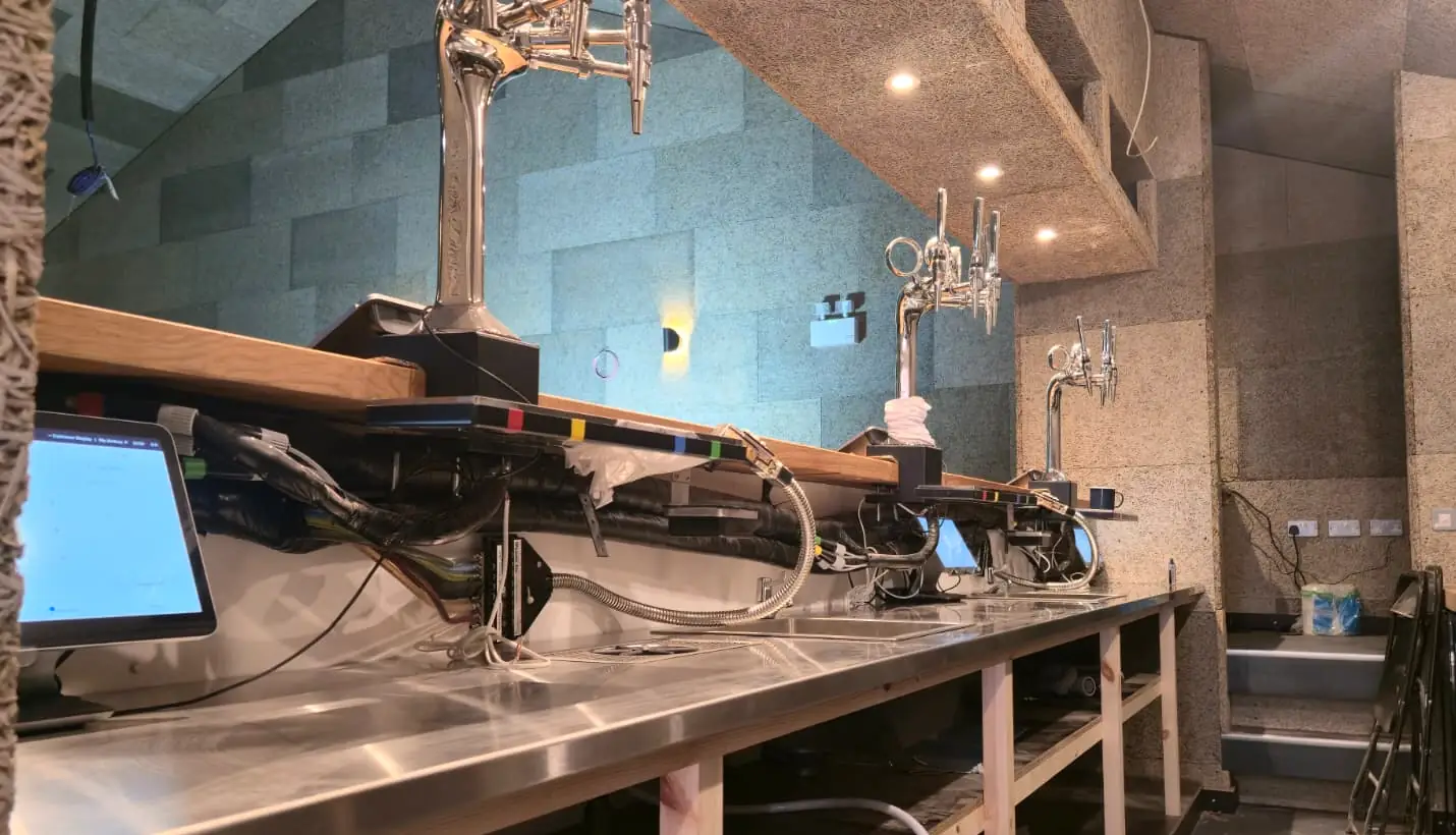 Point-of-sale terminals and cabling installed behind the bar at The Ruze
